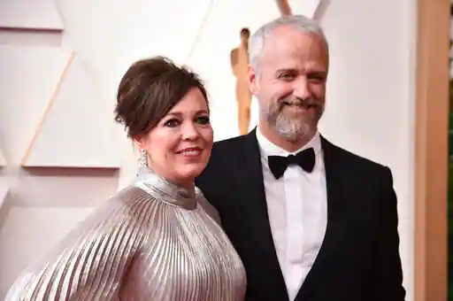 Olivia Colman, left, and Ed Sinclair arrive at the Oscars 